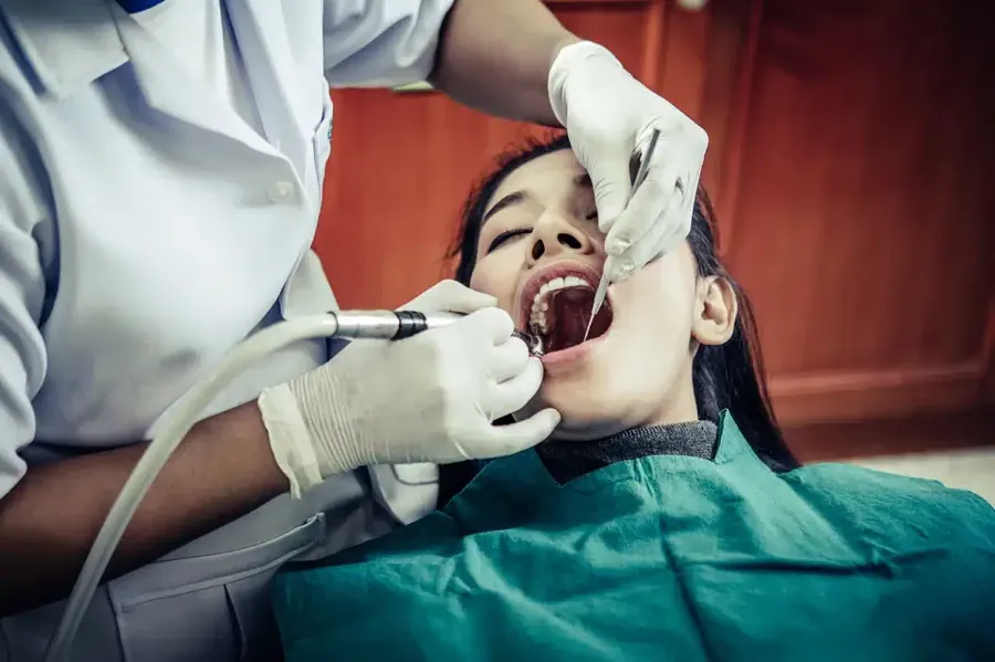 Dentist treating a patient urgently